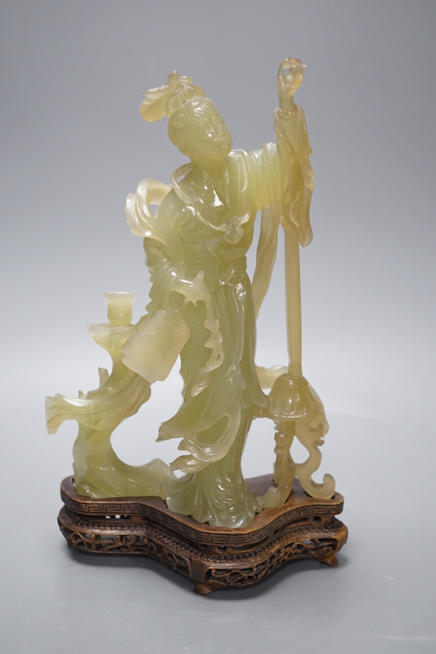 A Chinese carved bowenite jade figure of a lady on a hardwood stand 27cm